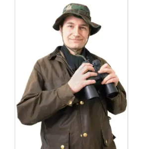 a man standing holding a pair of binoculars