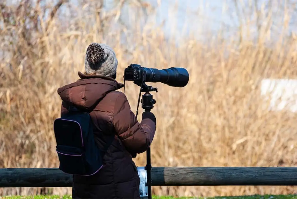 a woman with a camera on a tripod