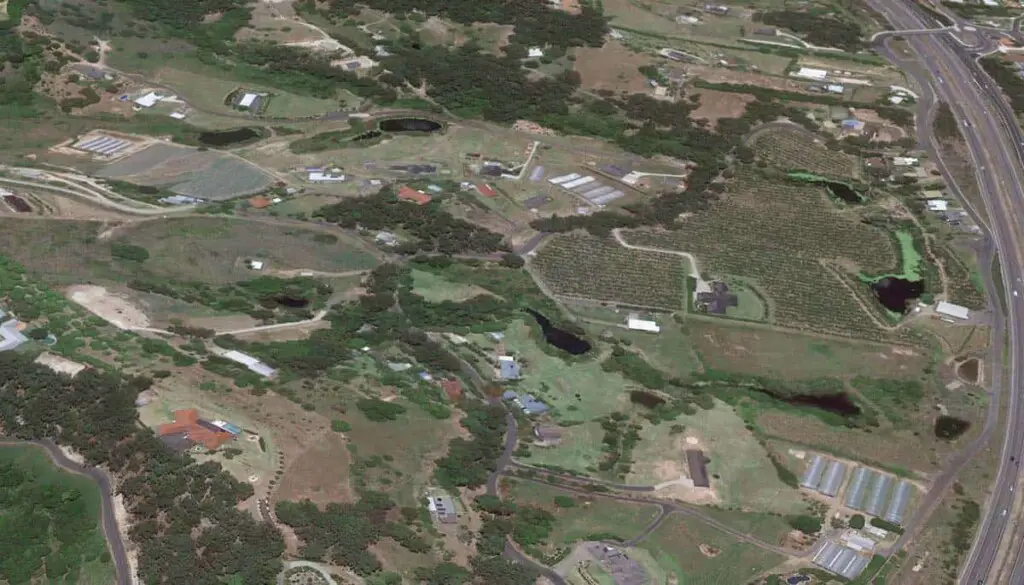 an aerial view of farmland showing how dams and ponds stand out to birds looking for water when flying