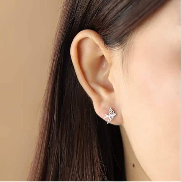 a woman's ear showing a sterling silver bird earring cute bird gifts