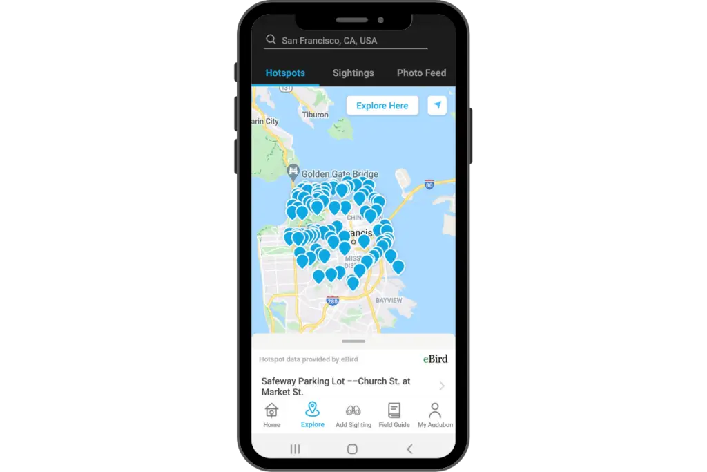 a smart phone with the Audubon Bird app Hot Spots page showing on the screen