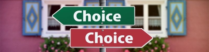 two signs with Choice written on them in white pointing in different directions