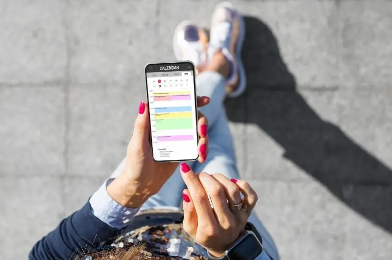 an overhead view of a woman using a smart phone