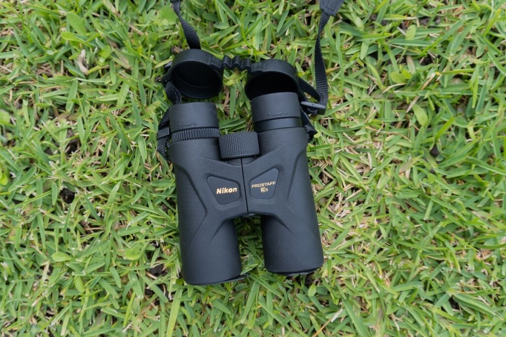 roof prism binoculars lying on grass