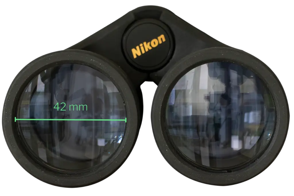 a close up of the front of a pair of binoculars showing the diameter of the objective lenses