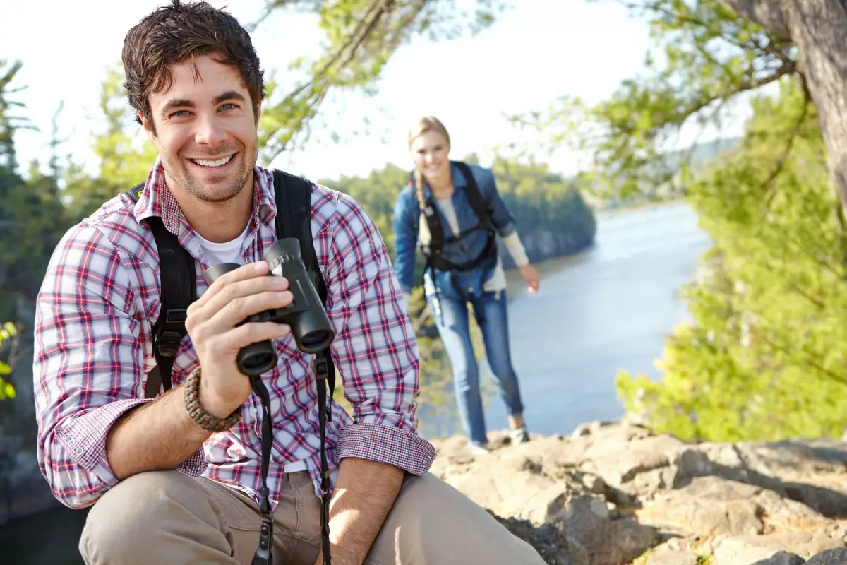 a young bird watching couple in the outdoors