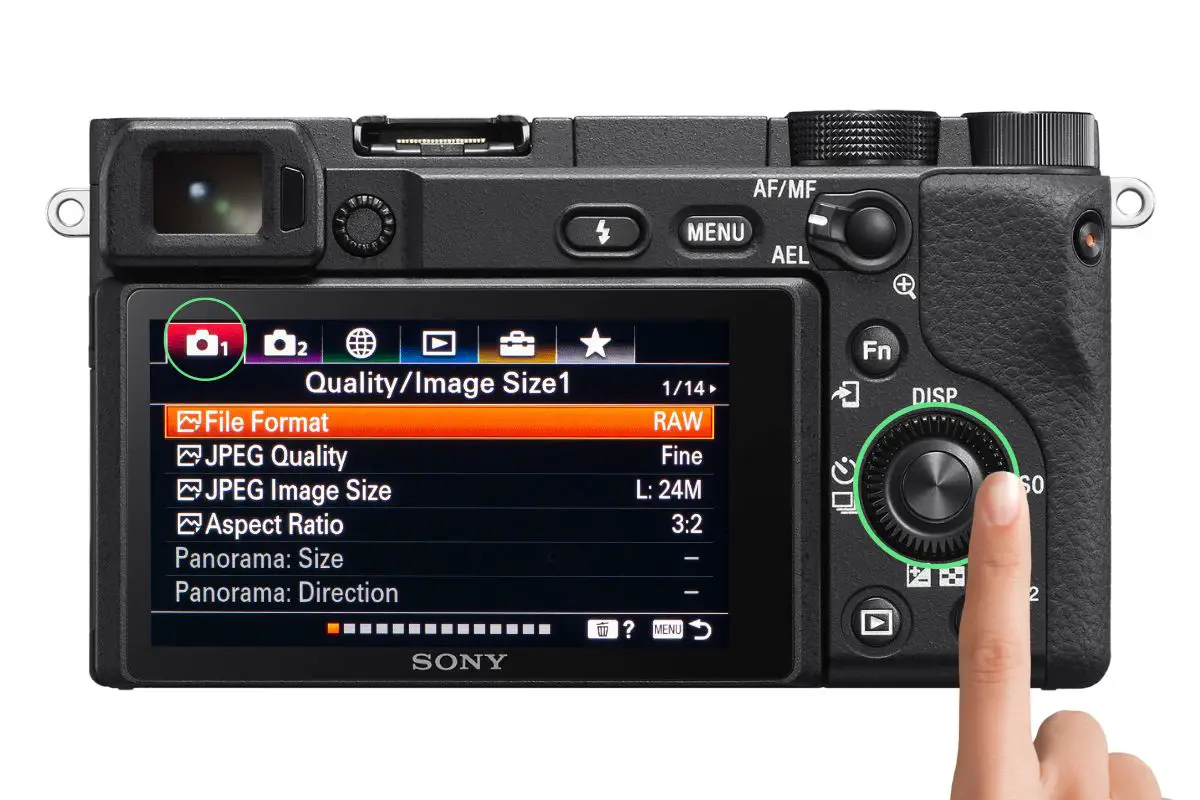 the rear of a Sony a6400 camera showing the Quality/Image Size menu with a woman's hand pressing the control wheel
