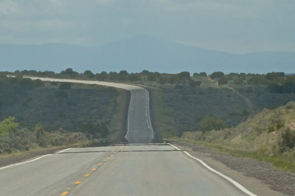 a road with heat haze rising from its surface