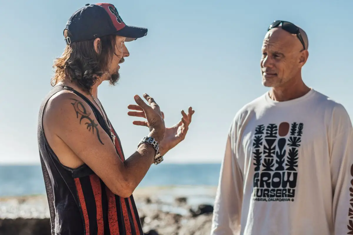 two men talking to each other outdoors